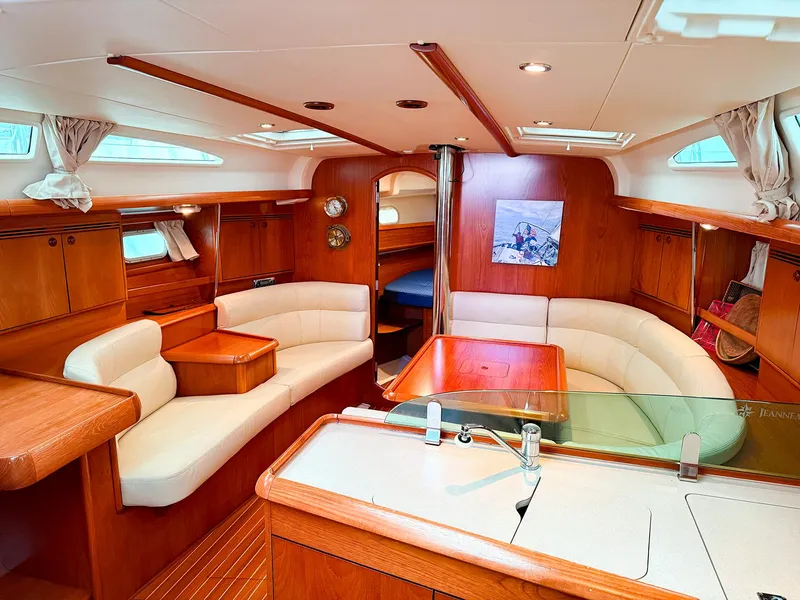 Slide: The Image of Luxurious interior of 2005 Jeanneau 40.3 yacht with elegant wood finish and cozy seating. - 19