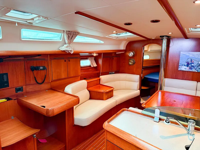 Slide: The Image of Interior of 2005 Jeanneau 40.3 yacht, featuring elegant wood finish and comfortable seating. - 21