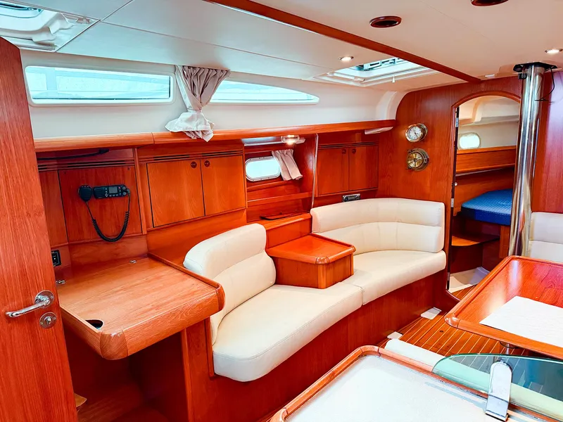 Slide: The Image of Interior of 2005 Jeanneau 40.3 yacht with elegant wood finish and cozy seating. - 22