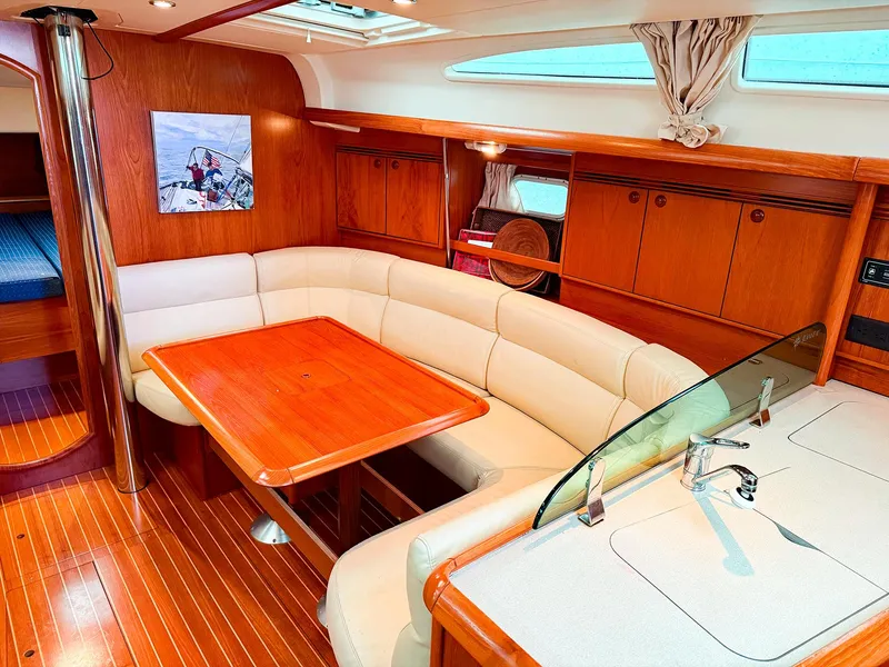 Slide: The Image of Interior of 2005 Jeanneau 40.3 yacht with elegant wood finish and cozy seating area. - 24