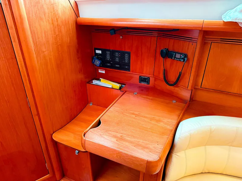 Slide: The Image of 2005 Jeanneau 40.3 yacht interior with navigation station and wooden cabinetry. - 25