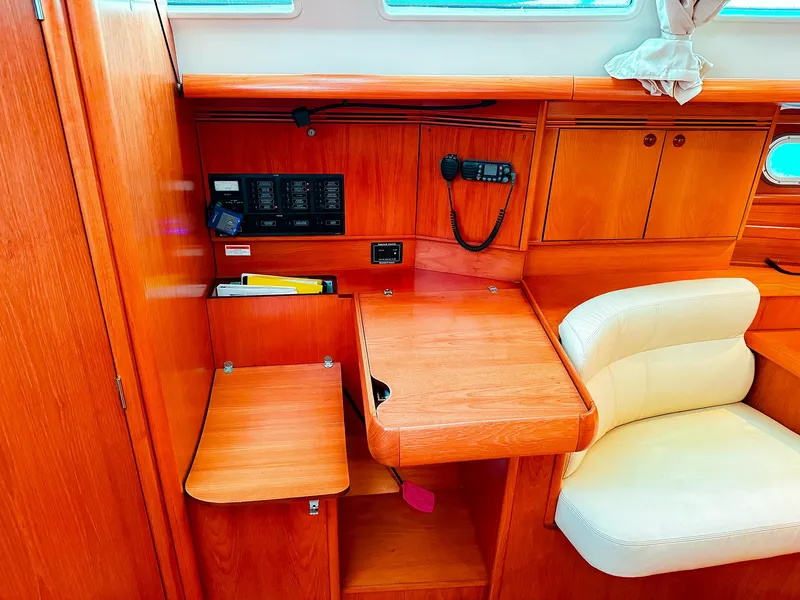 Slide: The Image of Jeanneau 40.3 2005 yacht interior with navigation station and wooden cabinetry. - 26