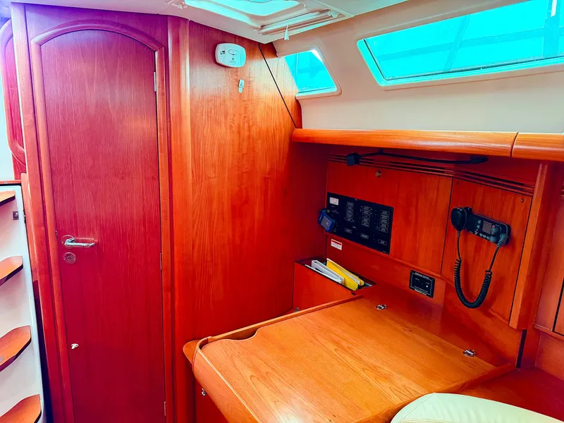 Slide: The Image of Interior of 2005 Jeanneau 40.3 sailboat with navigation station and wooden cabinetry. - 27