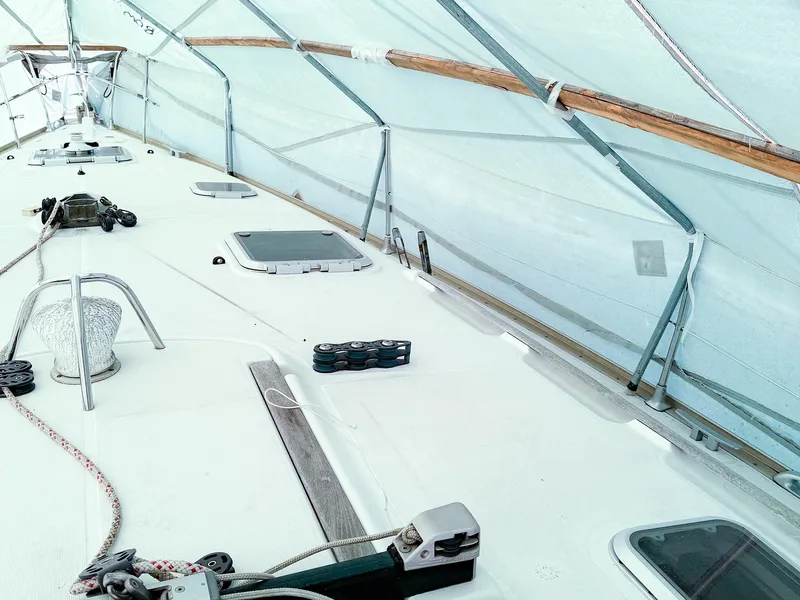 Slide: The Image of Jeanneau 40.3 sailboat deck under cover, showcasing hatches and rigging, 2005 model. - 3