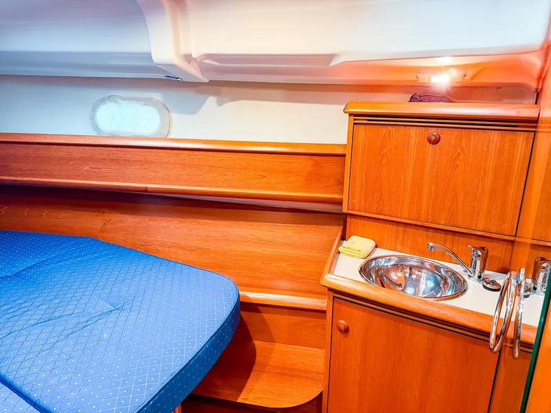 Slide: The Image of Interior cabin of 2005 Jeanneau 40.3 yacht with wooden finish and compact sink. - 32