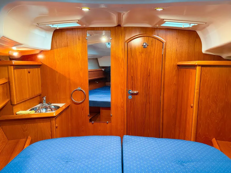 Slide: The Image of Interior of 2005 Jeanneau 40.3 yacht with wood finish and blue upholstery. - 35