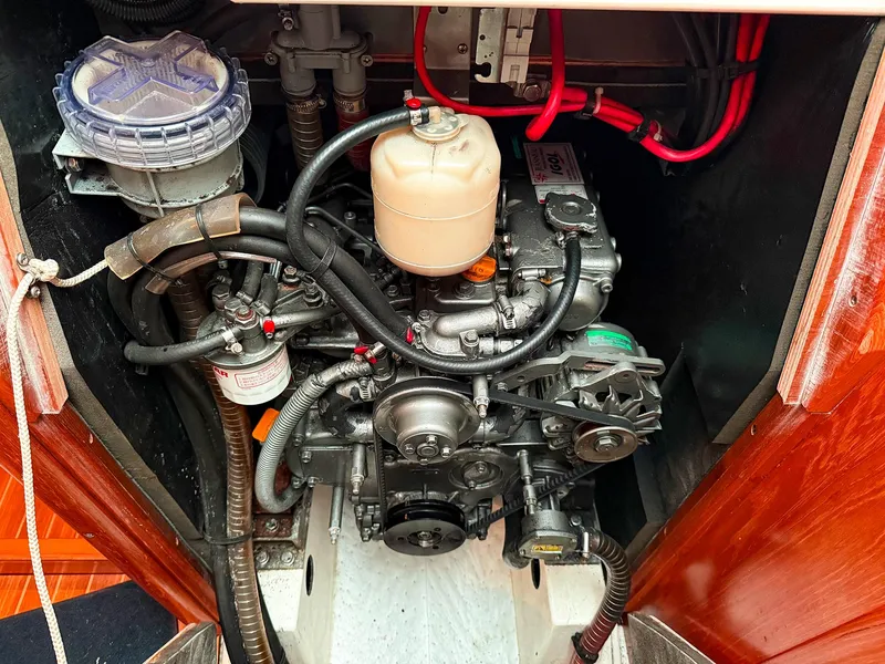 Slide: The Image of Engine compartment of a 2005 Jeanneau 40.3 sailboat, showcasing mechanical components and wiring. - 36