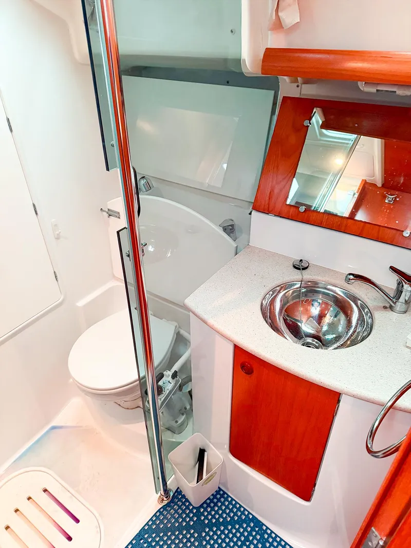 Slide: The Image of 2005 Jeanneau 40.3 yacht bathroom with modern sink, toilet, and wooden accents. - 38