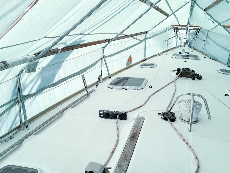 Slide: The Image of Covered deck of a 2005 Jeanneau 40.3 sailboat, showcasing rigging and hatches. - 4