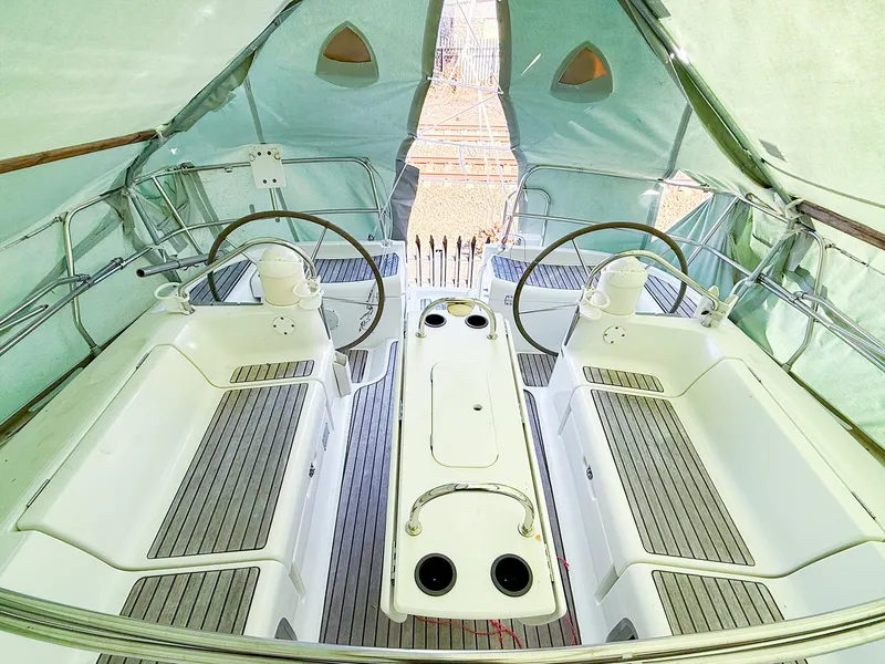 Slide: The Image of 2005 Jeanneau 40.3 sailboat cockpit with dual steering wheels and covered deck. - 6