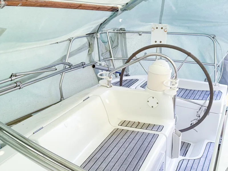 Slide: The Image of 2005 Jeanneau 40.3 yacht cockpit with steering wheel and seating area. - 8
