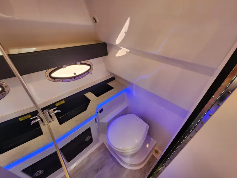 Slide: The Image of 2019 Formula 330 Crossover Bowrider OB bathroom with modern fixtures and ambient lighting. - 12