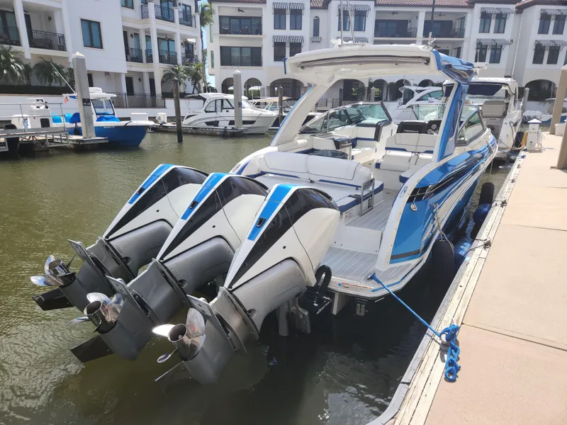 Slide: The Image of 2019 Formula 330 Crossover Bowrider OB docked with triple outboard engines. - 14