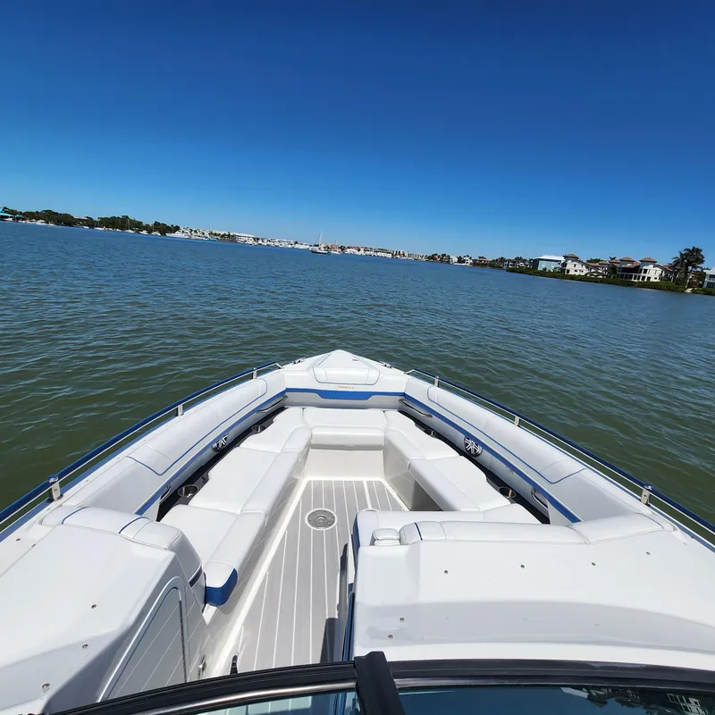 Slide: The Image of 2019 Formula 330 Crossover Bowrider OB on calm water, clear sky. - 16
