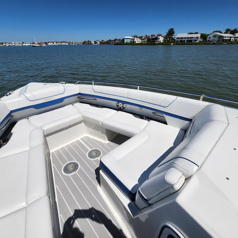 Slide: The Image of 2019 Formula 330 Crossover Bowrider OB, spacious seating, scenic waterfront view. - 17
