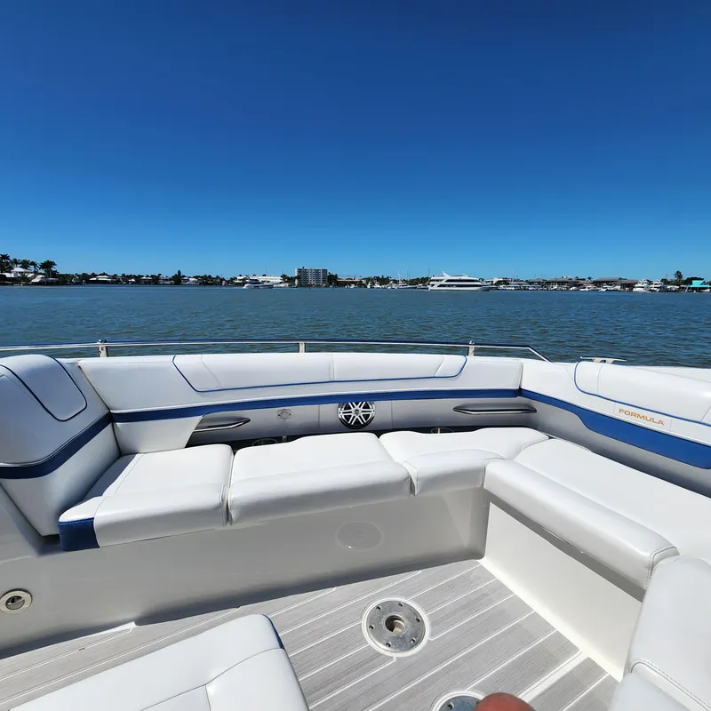 Slide: The Image of 2019 Formula 330 Crossover Bowrider OB, spacious seating, scenic waterfront view. - 18