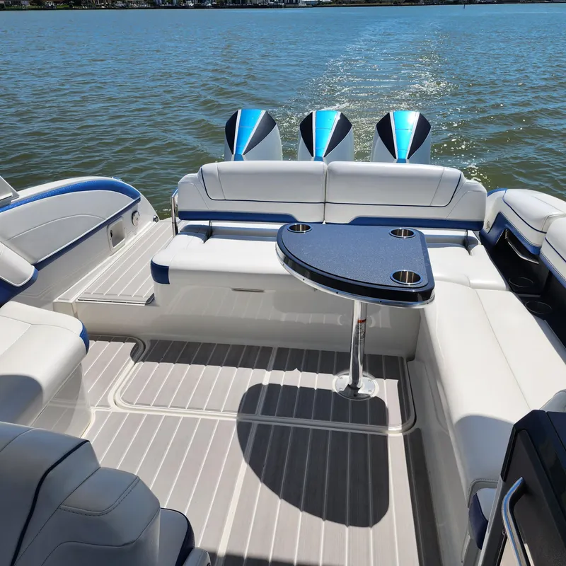 Slide: The Image of 2019 Formula 330 Crossover Bowrider OB interior with seating and table on the water. - 19