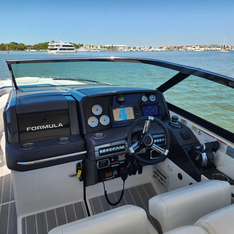 Slide: The Image of 2019 Formula 330 Crossover Bowrider OB dashboard with navigation screens on a sunny day. - 20