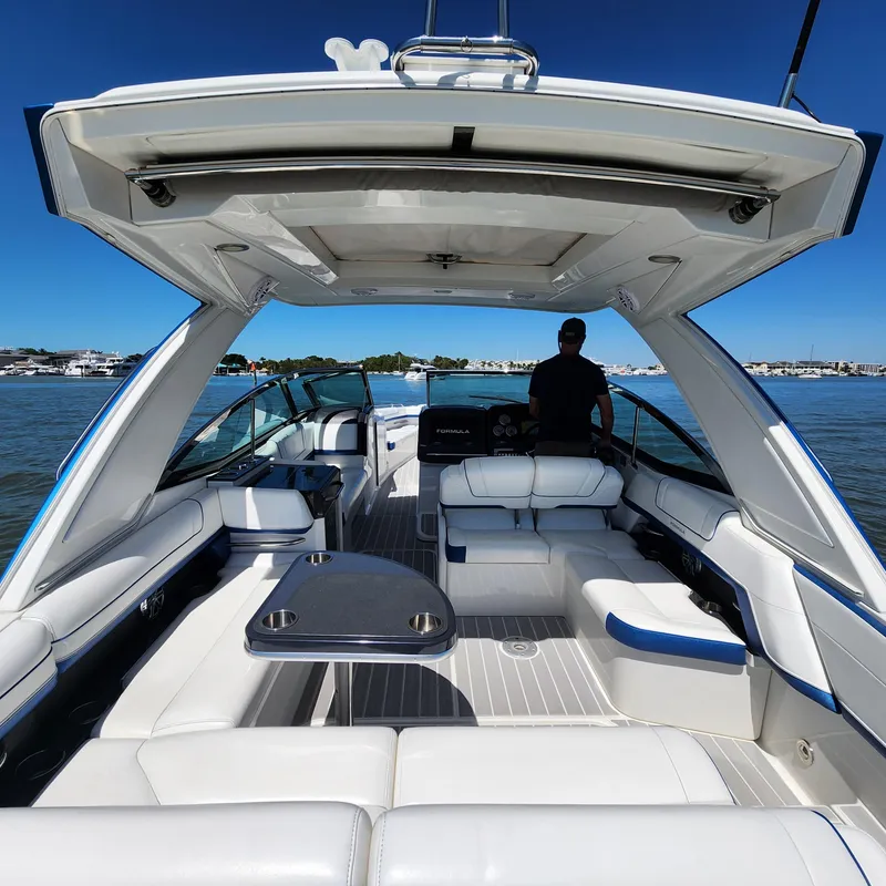 Slide: The Image of 2019 Formula 330 Crossover Bowrider OB on water, featuring spacious seating and sleek design. - 25
