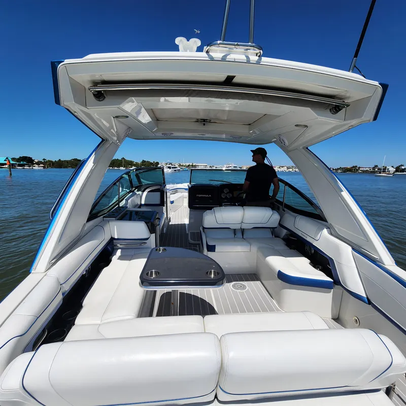 Slide: The Image of 2019 Formula 330 Crossover Bowrider OB on water, featuring spacious seating and sleek design. - 26