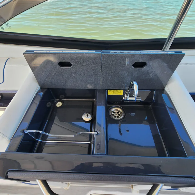 Slide: The Image of 2019 Formula 330 Crossover Bowrider OB sink area with dual basins and faucet. - 27