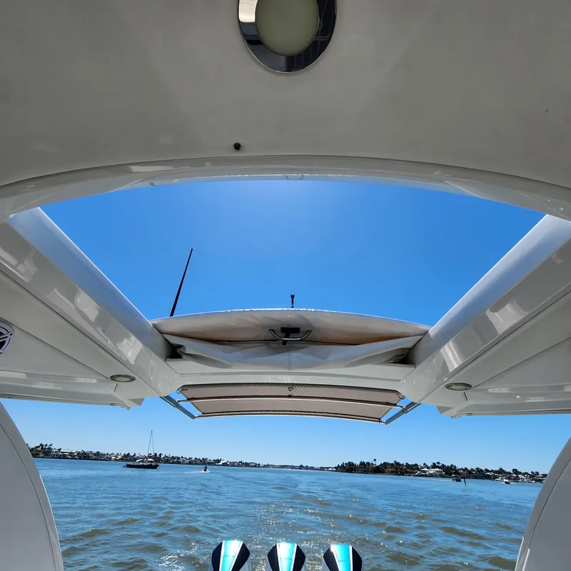Slide: The Image of 2019 Formula 330 Crossover Bowrider OB on water, view from under canopy. - 29