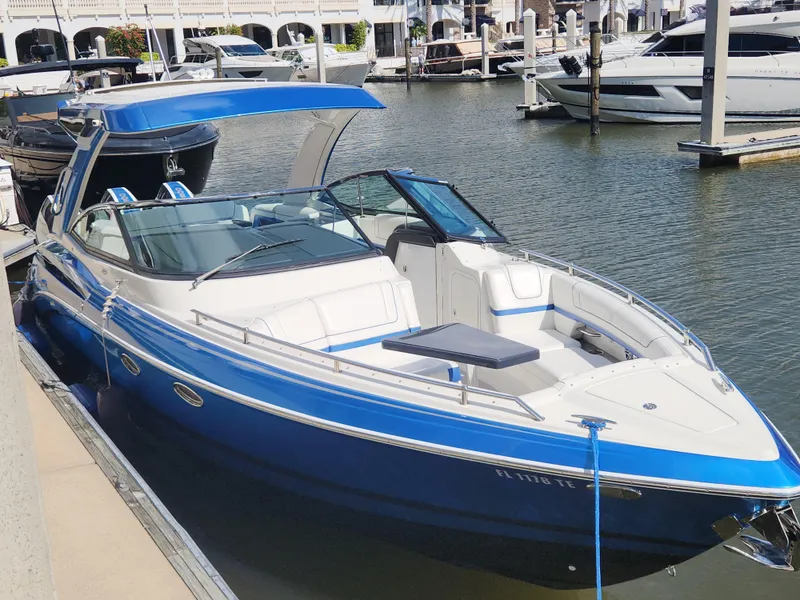 Slide: The Image of 2019 Formula 330 Crossover Bowrider OB in marina, blue and white design. - 3