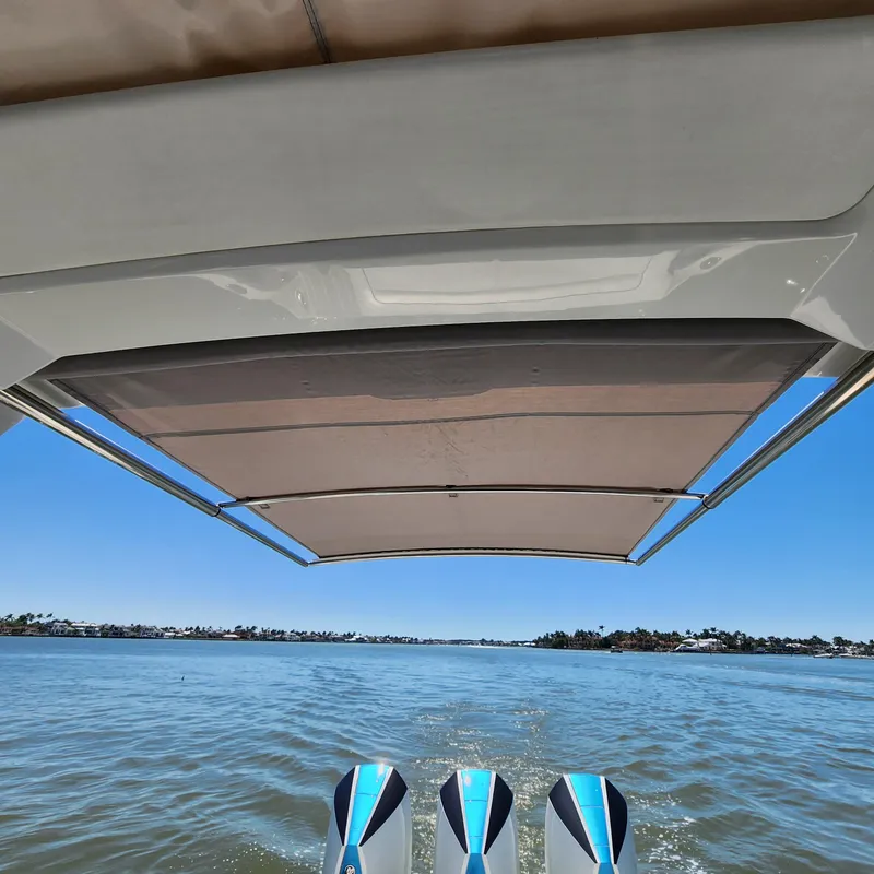 Slide: The Image of 2019 Formula 330 Crossover Bowrider OB on water, view from under canopy. - 31