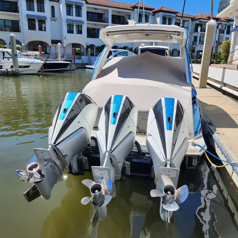 Slide: The Image of 2019 Formula 330 Crossover Bowrider OB with triple outboard engines docked at marina. - 34