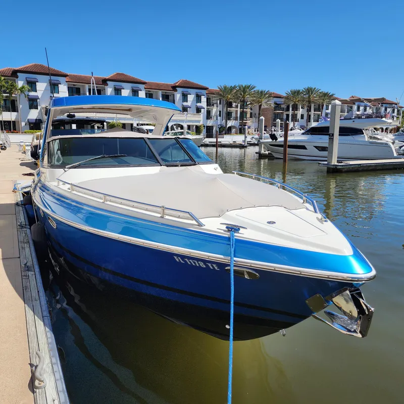Slide: The Image of 2019 Formula 330 Crossover Bowrider OB docked at marina, blue hull, sunny day. - 35
