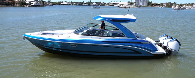 Slide: The Image of 2019 Formula 330 Crossover Bowrider OB on calm water, showcasing sleek design and powerful engines. - 38