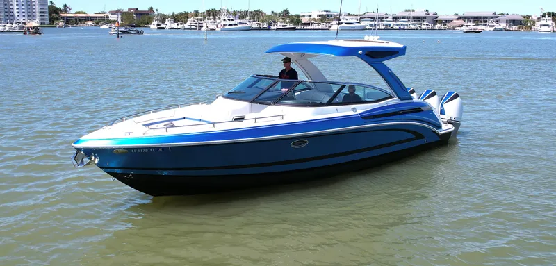 Slide: The Image of 2019 Formula 330 Crossover Bowrider OB on calm water, showcasing sleek design and vibrant blue color. - 39