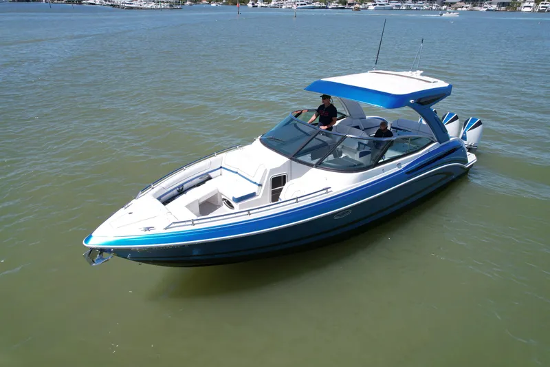 Slide: The Image of 2019 Formula 330 Crossover Bowrider OB on calm water, featuring sleek design and spacious seating. - 42