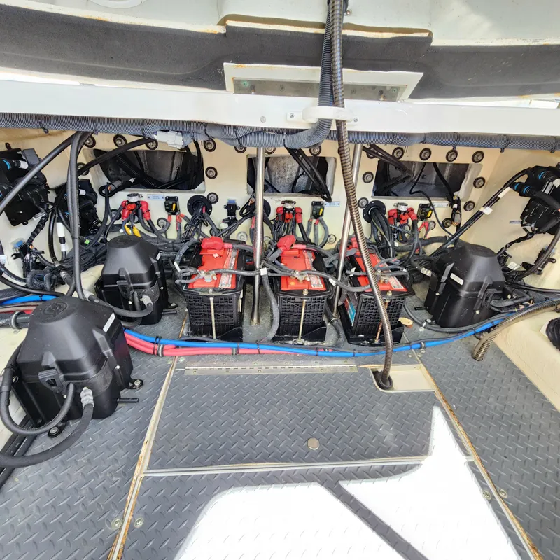 Slide: The Image of Engine compartment of a 2019 Formula 330 Crossover Bowrider OB, showcasing batteries and wiring. - 49