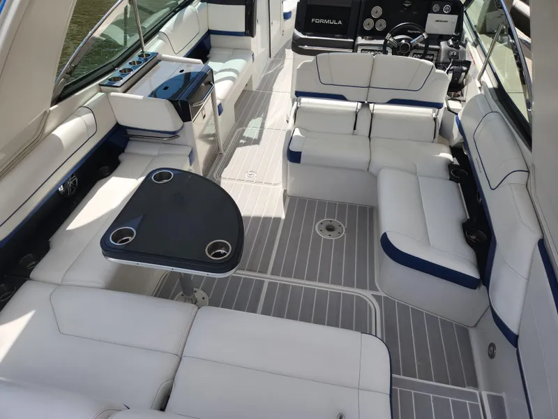 Slide: The Image of 2019 Formula 330 Crossover Bowrider OB interior with white seating and sleek design. - 7
