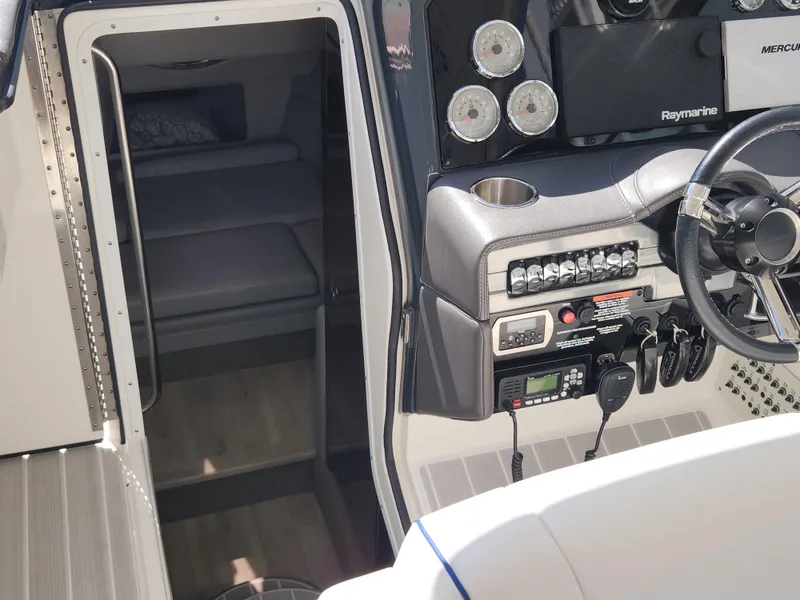 Slide: The Image of 2019 Formula 330 Crossover Bowrider OB cockpit with steering wheel and cabin entrance. - 8