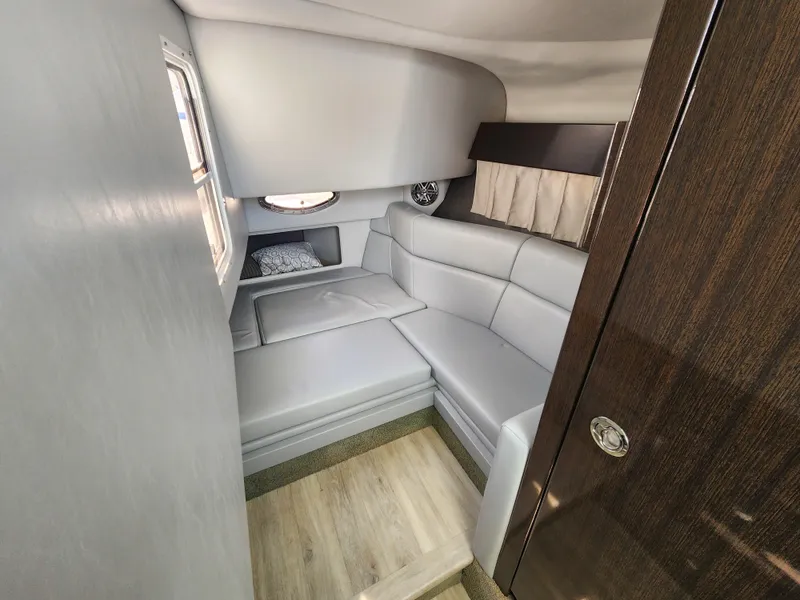 Slide: The Image of 2019 Formula 330 Crossover Bowrider OB cabin interior with modern seating and window. - 9