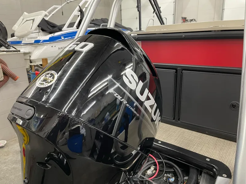 Slide: The Image of Bentley Pontoons 200 Fish-N-Cruise 2025 with Suzuki outboard motor in a showroom. - 18