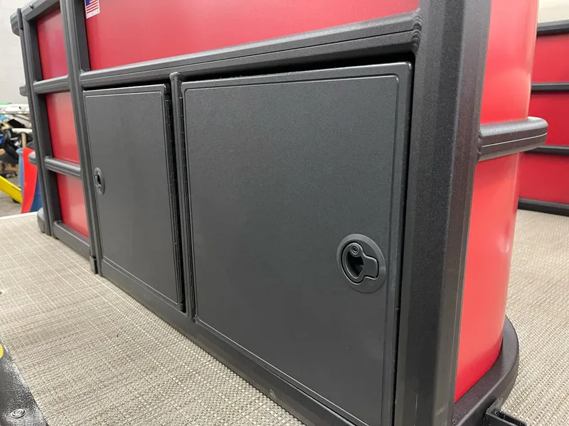 Slide: The Image of 2025 Bentley Pontoons 200 Fish-N-Cruise storage compartment, featuring sleek black doors and red accents. - 27