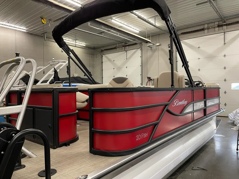 Slide: The Image of 2025 Bentley Pontoons 200 Fish-N-Cruise in a showroom, featuring a sleek red design. - 3