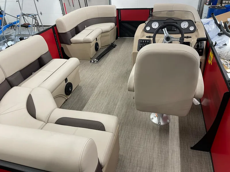 Slide: The Image of 2025 Bentley Pontoons 200 Fish-N-Cruise interior with beige seating and modern dashboard. - 32