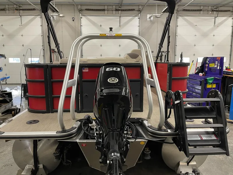 Slide: The Image of 2025 Bentley Pontoons 200 Fish-N-Cruise with outboard motor in a garage setting. - 4