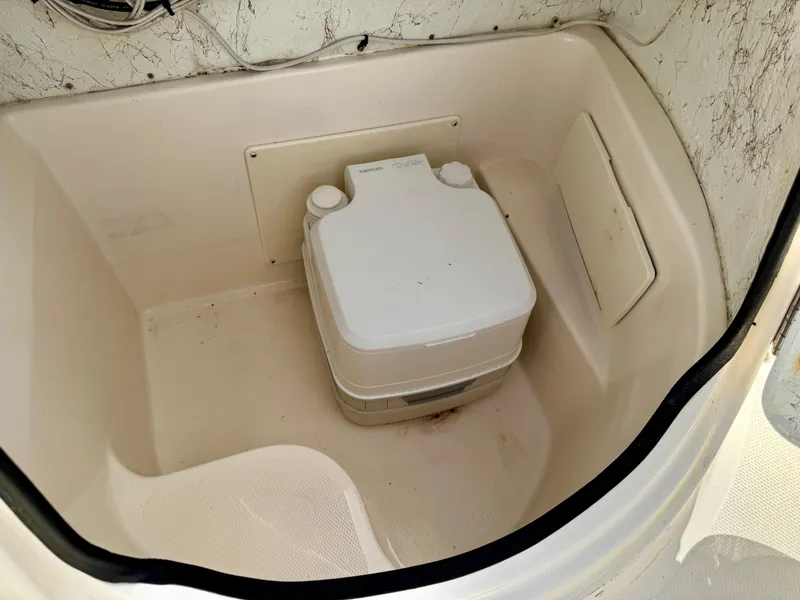 Slide: The Image of 2008 Hurricane FunDeck 211 O/B boat interior with portable toilet. - 13