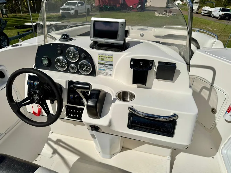 Slide: The Image of 2008 Hurricane FunDeck 211 O/B boat dashboard with steering wheel and navigation controls. - 14