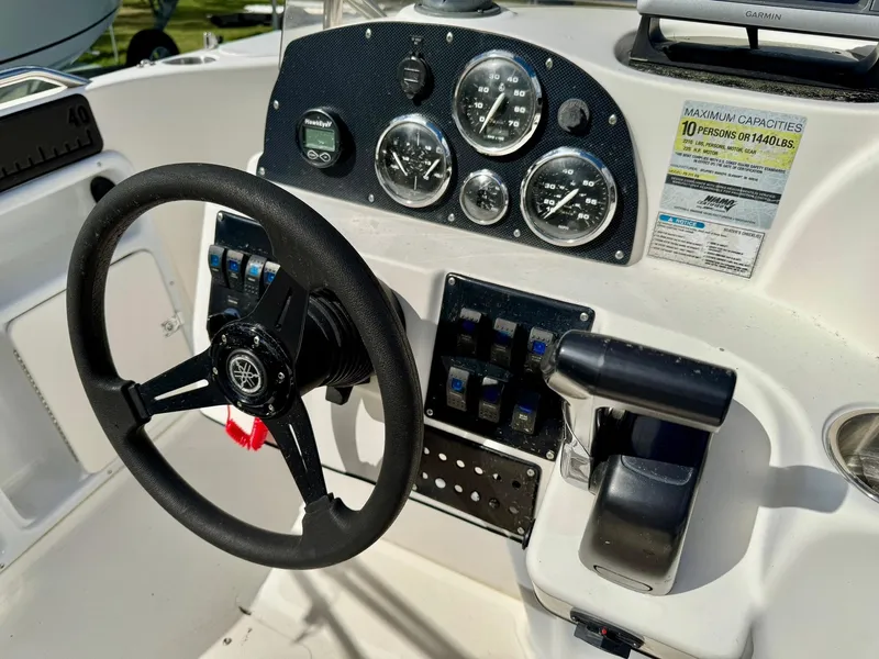 Slide: The Image of 2008 Hurricane FunDeck 211 O/B boat dashboard with steering wheel and control panel. - 15
