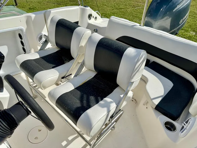 Slide: The Image of 2008 Hurricane FunDeck 211 O/B boat interior with dual black and white seats. - 18