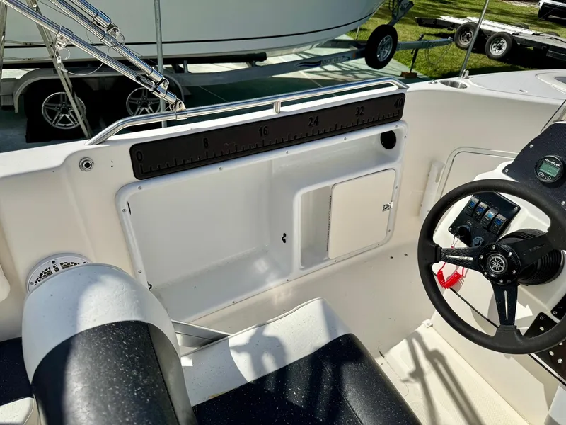 Slide: The Image of 2008 Hurricane FunDeck 211 O/B boat interior with steering wheel and seating area. - 19