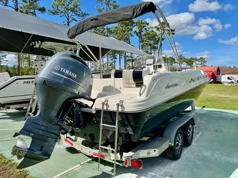 Slide: The Image of 2008 Hurricane FunDeck 211 O/B boat with Yamaha engine on trailer, outdoors. - 2