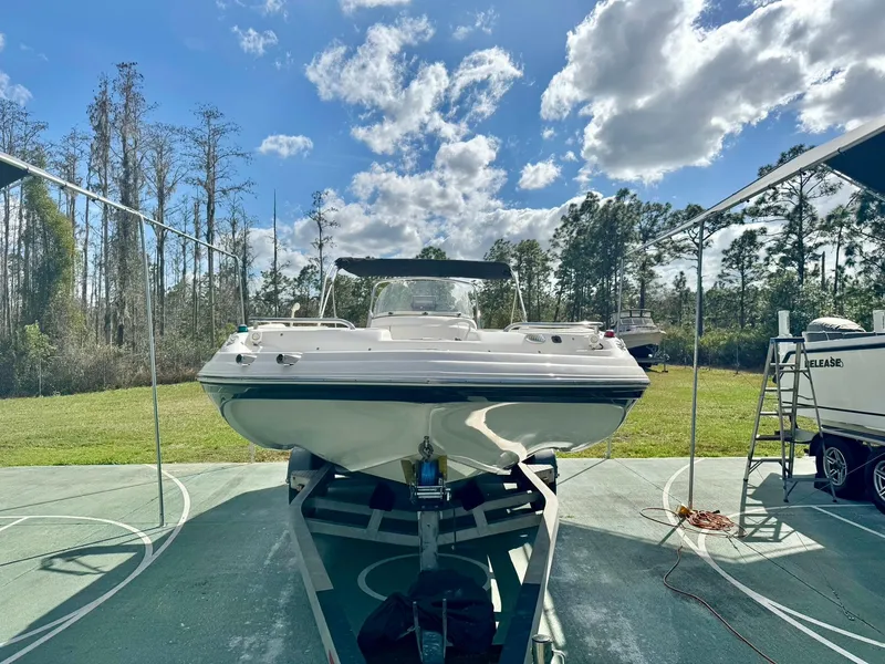 Slide: The Image of 2008 Hurricane FunDeck 211 O/B boat on trailer under a clear sky. - 4