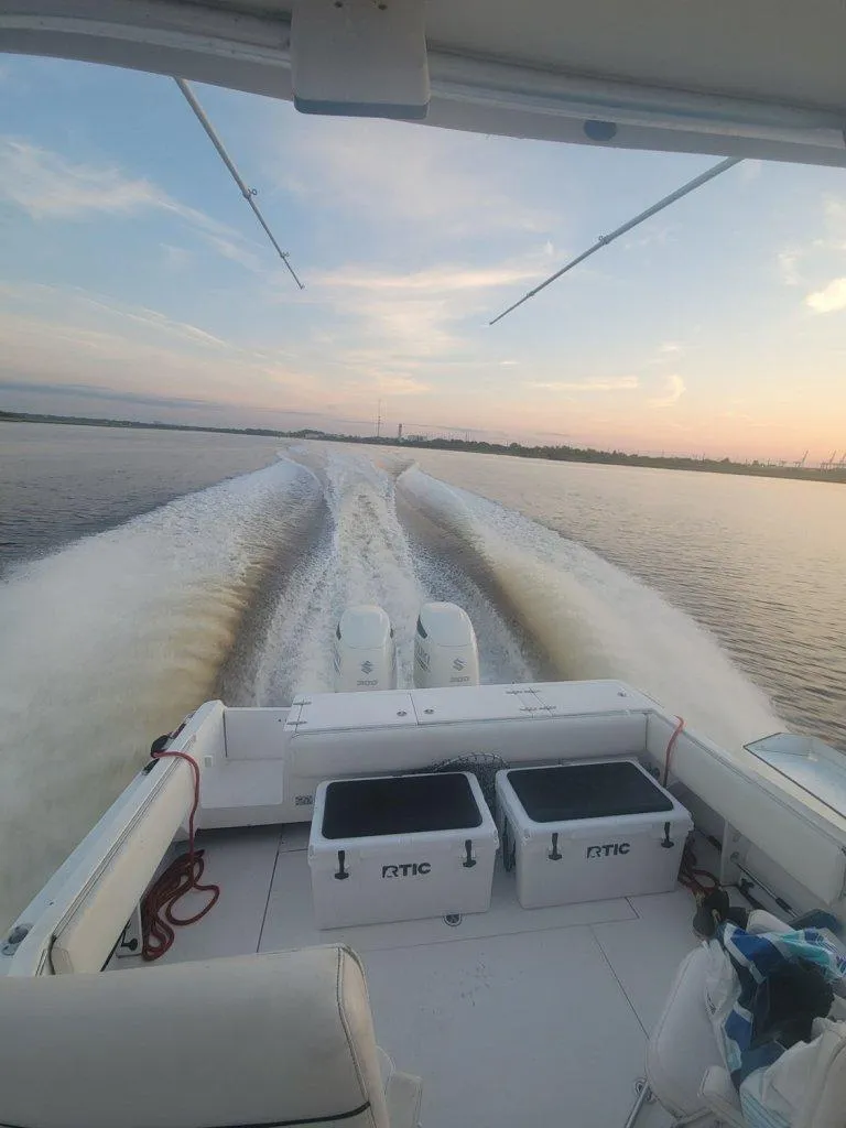 Slide: The Image of 2005 Stamas 290 Express boat cruising on calm waters at sunset. - 11